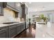 Gourmet kitchen boasts a stylish backsplash, gray cabinets, and stainless steel appliances, and large island at 605 Stone Field Nw Run, Marietta, GA 30060