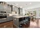 Modern kitchen with gray cabinets, an island with seating, and a view of the dining area at 605 Stone Field Nw Run, Marietta, GA 30060