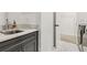 Laundry room with gray cabinets, marble countertop, stainless steel sink, and adjacent laundry machines at 605 Stone Field Nw Run, Marietta, GA 30060