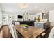 Open-concept living space featuring hardwood floors, built-in shelving, a dining area, and a modern kitchen at 605 Stone Field Nw Run, Marietta, GA 30060