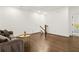 Empty living room area with hardwood floors, simple decor, and stairs leading to the upper floor at 605 Stone Field Nw Run, Marietta, GA 30060