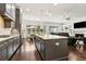 Open-concept kitchen flows into living and dining areas with modern gray cabinets and stainless appliances at 605 Stone Field Nw Run, Marietta, GA 30060