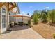 View of patio space with pavers, umbrella and outdoor seating and mulched backyard at 605 Stone Field Nw Run, Marietta, GA 30060