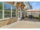 Back patio featuring brick exterior, wood awning, patio pavers, outdoor seating, and privacy wall at 605 Stone Field Nw Run, Marietta, GA 30060