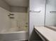 Bright bathroom featuring a vanity with ample counter space and a built-in tub shower at 7235 Hummingbird Ln, Winston, GA 30187
