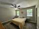 Neutral bedroom featuring a ceiling fan and wood-look floors at 7235 Hummingbird Ln, Winston, GA 30187