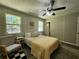 Serene bedroom with a cozy rug, neutral walls, a ceiling fan, and a bright window view at 7235 Hummingbird Ln, Winston, GA 30187