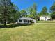 Charming single-story home with a well-maintained lawn and inviting curb appeal on a sunny day at 7235 Hummingbird Ln, Winston, GA 30187