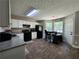 Clean kitchen with white cabinets, black appliances, wood floors, and breakfast bar area at 7235 Hummingbird Ln, Winston, GA 30187