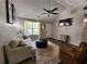 Bright living room with dark wood floors, neutral decor, vaulted ceilings, and comfortable seating at 7235 Hummingbird Ln, Winston, GA 30187