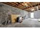 Unfinished basement with exposed ceilings and concrete floor, offering potential for customization at 9148 Homewood Dr, Riverdale, GA 30274