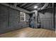Finished basement area with wood-look flooring, a small window, and painted walls at 9148 Homewood Dr, Riverdale, GA 30274