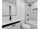 Modern bathroom featuring a large mirror, updated vanity, and tiled shower/tub combo at 9148 Homewood Dr, Riverdale, GA 30274