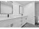 Bright bathroom featuring a double vanity with black accents, quartz countertop, and modern fixtures at 9148 Homewood Dr, Riverdale, GA 30274
