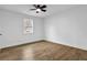 Inviting bedroom with a window view, ceiling fan, and wood-look flooring at 9148 Homewood Dr, Riverdale, GA 30274