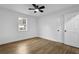 Cozy bedroom with natural light, ceiling fan, and wood-look floors at 9148 Homewood Dr, Riverdale, GA 30274