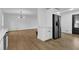 Open floor plan of living room flows into kitchen with stainless refrigerator at 9148 Homewood Dr, Riverdale, GA 30274