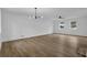 Spacious living room featuring new wood flooring, modern lighting, and bright windows at 9148 Homewood Dr, Riverdale, GA 30274