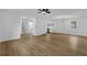 Open-concept living area with hardwood floors, recessed lights, and access to the kitchen and staircase at 9148 Homewood Dr, Riverdale, GA 30274