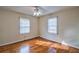 Comfortable bedroom featuring hardwood floors, a ceiling fan, and two windows for ample natural light at 933 Dell Se Ave, Smyrna, GA 30080