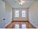 Inviting bedroom featuring hardwood floors, a ceiling fan, and two windows for natural light at 933 Dell Se Ave, Smyrna, GA 30080