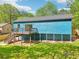 The backyard showcases a spacious grassy area with a wood deck and stairs at 1596 Pontiac Se Pl, Atlanta, GA 30315