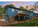 The backyard showcases a spacious grassy area with a wood deck and stairs at 1596 Pontiac Se Pl, Atlanta, GA 30315