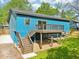 This backyard features a wood deck, stairs and an expansive grassy area at 1596 Pontiac Se Pl, Atlanta, GA 30315