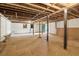 Spacious unfinished basement featuring concrete floor, exposed beams, and a blue exterior door at 1596 Pontiac Se Pl, Atlanta, GA 30315