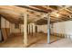 Unfinished basement with concrete floor, exposed wood beams, support columns, and storage space at 1596 Pontiac Se Pl, Atlanta, GA 30315