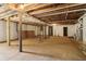 Unfinished basement with concrete floor, exposed wooden beams, and support columns at 1596 Pontiac Se Pl, Atlanta, GA 30315