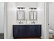 Bathroom features a dual sink vanity with chrome fixtures, bright lighting, and a separate toilet room at 1596 Pontiac Se Pl, Atlanta, GA 30315