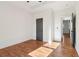 Bedroom with hardwood floors and access to the next room with gray doors at 1596 Pontiac Se Pl, Atlanta, GA 30315