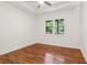 Bedroom with wood flooring, ceiling fan, and bright view from the large window at 1596 Pontiac Se Pl, Atlanta, GA 30315