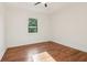 Bedroom with wood flooring and a window view of the surrounding trees at 1596 Pontiac Se Pl, Atlanta, GA 30315