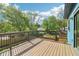 Large wooden deck with black railings offering views of the trees and backyard at 1596 Pontiac Se Pl, Atlanta, GA 30315