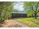Quaint home with a charming front porch, surrounded by trees, and ample driveway space at 1596 Pontiac Se Pl, Atlanta, GA 30315