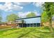 Back exterior featuring elevated deck, blue siding, and a spacious green lawn at 1596 Pontiac Se Pl, Atlanta, GA 30315