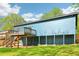 Home's back exterior, with a wooden deck, support beams, and ample green yard space at 1596 Pontiac Se Pl, Atlanta, GA 30315