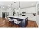Bright kitchen with an island, featuring a breakfast bar, sleek counter tops, and modern appliances at 1596 Pontiac Se Pl, Atlanta, GA 30315