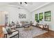 Contemporary living room featuring hardwood floors, neutral tones, and plenty of natural light at 1596 Pontiac Se Pl, Atlanta, GA 30315