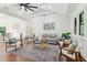 Bright and airy living room with high ceilings, stylish furniture, and hardwood floors at 1596 Pontiac Se Pl, Atlanta, GA 30315
