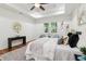 Bright main bedroom with wood floors, ceiling fan, tray ceiling, window view, and artwork at 1596 Pontiac Se Pl, Atlanta, GA 30315