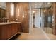 Bathroom features a dark wood vanity, tile walls, and frameless glass shower at 2233 Peachtree Ne Rd # 1207, Atlanta, GA 30309