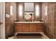 Elegant bathroom with marble vanity, dark wood cabinetry, and designer lighting fixtures at 2233 Peachtree Ne Rd # 1207, Atlanta, GA 30309
