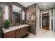 Sleek bathroom showcasing a modern vanity, sconces, and access to a spacious closet at 2233 Peachtree Ne Rd # 1207, Atlanta, GA 30309