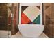 Elegant bathroom boasts a modern soaking tub set against unique geometric artwork at 2233 Peachtree Ne Rd # 1207, Atlanta, GA 30309