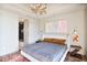 Bedroom with neutral tones, light fixture and rug, and door leading to bathroom with glass shower at 2233 Peachtree Ne Rd # 1207, Atlanta, GA 30309