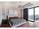 Modern bedroom with a luxurious bed, stylish lighting, balcony and city views at 2233 Peachtree Ne Rd # 1207, Atlanta, GA 30309