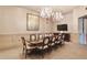 The formal dining room offers a large table, a chandelier, and a wall-mounted television at 2233 Peachtree Ne Rd # 1207, Atlanta, GA 30309